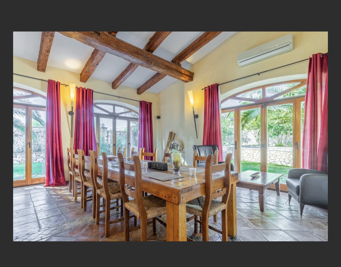 Mediterranean dining room with wooden beams